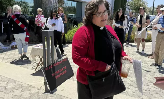 The Rev. Oona Casanova Vazquez, lead pastor of the South Bay Church of the Nazarene in Torrance, stands outside Santa Ana Immigration Court during a prayer vigil for immigrants in Santa Ana, Calif., Thursday, July 31, 2025. (AP Photo/Deepa Bharath)