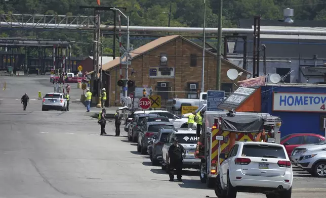 Emergency crew gather after an explosion at the Clairton Coke Works, a U.S. Steel coking plant, Monday, Aug 11, 2025, in Clairton, Penn. (AP Photo/Gene Puskar)