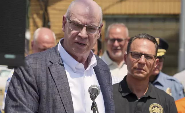 Pennsylvania Governor Josh Shapiro, right, listens as U.S. Steel President and CEO David B. Burritt answers a question during meeting with media at the Clairton Coke Works, a U.S. Steel plant, in Clairton, Pa., Tuesday, Aug. 12, 2025. (AP Photo/Gene J. Puskar)