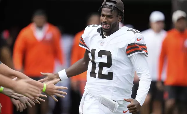 Cleveland Browns quarterback Shedeur Sanders runs onto the field during player introductions before an NFL preseason football game against the Los Angeles Rams, Saturday, Aug. 23, 2025, in Cleveland. (AP Photo/Sue Ogrocki)