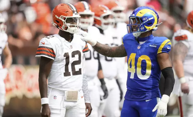 Cleveland Browns quarterback Shedeur Sanders (12) talks to Los Angeles Rams linebacker Tony Fields II (40) during the second half of an NFL preseason football game Saturday, Aug. 23, 2025, in Cleveland. (AP Photo/Sue Ogrocki)