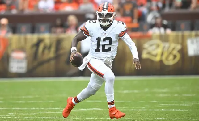 Cleveland Browns quarterback Shedeur Sanders (12) runs against the Los Angeles Rams in the second half of an NFL preseason football game Saturday, Aug. 23, 2025, in Cleveland. (AP Photo/David Richard)