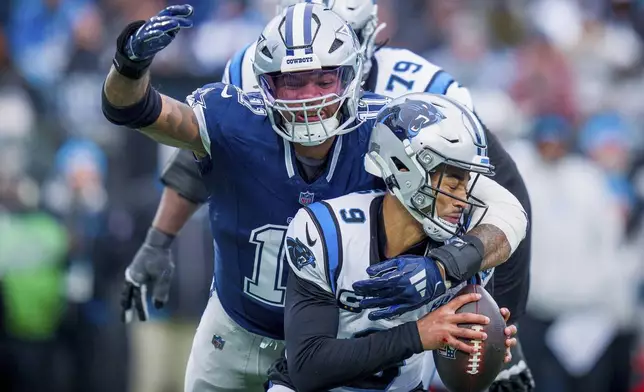 FILE - Dallas Cowboys linebacker Micah Parsons (11) sacks Carolina Panthers quarterback Bryce Young (9) during an NFL football game on Sunday, Dec. 15, 2024, in Charlotte, N.C. (AP Photo/Rusty Jones, File)