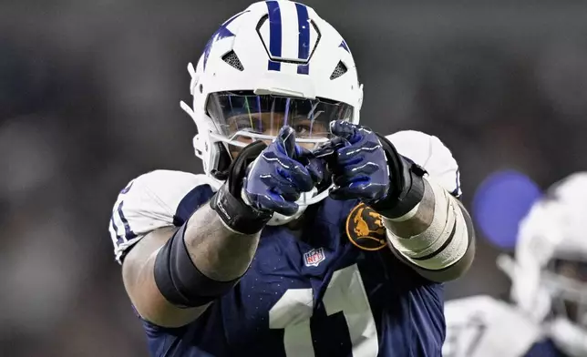 FILE - Dallas Cowboys linebacker Micah Parsons (11) celebrates after sacking New York Giants quarterback Drew Lock during an NFL football game in Arlington, Texas, Thursday, Nov. 28, 2024. (AP Photo/Jerome Miron, File)