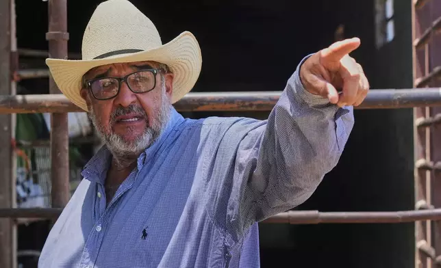 Martín Ibarra Vargas points to his corrals at his small ranch in Hermosillo, Sonora state, Tuesday, July 29, 2025. (AP Photo/Fernando Llano)