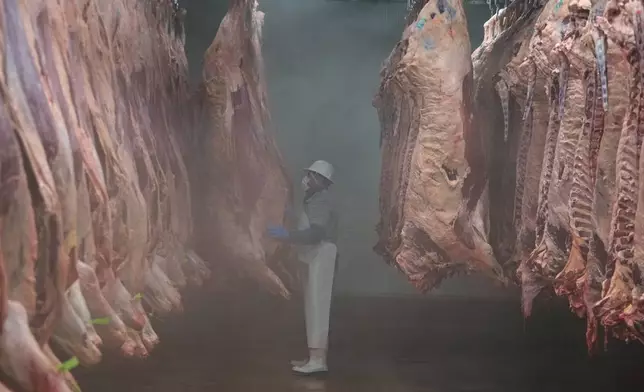 A worker sorts beef carcasses at an export-oriented slaughterhouse in Hermosillo, Mexico, Monday, July 28, 2025. (AP Photo/Fernando Llano)