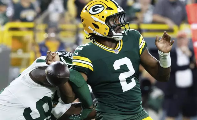 New York Jets' Leonard Taylor III forces Green Bay Packers' Malik Willis to fumble in the endzone during the first half of a preseason NFL football game Saturday, Aug. 9, 2025, in Green Bay, Wis. (AP Photo/Mike Roemer)