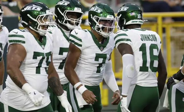 New York Jets' Justin Fields is congratulated after running for a touchdown during the first half of a preseason NFL football game against the Green Bay Packers Saturday, Aug. 9, 2025, in Green Bay, Wis. (AP Photo/Matt Ludtke)