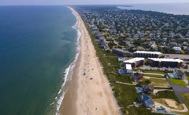FILE - The Atlantic Ocean, beach and houses are at Duck, Outer Banks, North Carolina, on Aug. 24, 2023. (AP Photo/Ted Shaffrey, file)