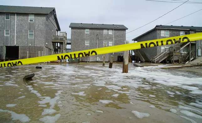Sea water from Hurricane Erin surges under the Cape Hatteras Motel in Buxton, N.C., on Wednesday, Aug. 20, 2025. (AP Photo/Allen G. Breed)
