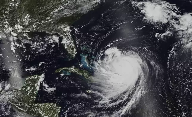 In this Monday, Aug. 18, 2025 satellite image released by NASA, Hurricane Erin continues its slow west-northwest trajectory across the Atlantic Ocean. (NASA Worldview, Earth Observing System Data and Information System (EOSDIS) via AP)