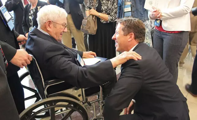 Rep. Adrian Smith greets Congressional Gold Medal recipient Donald McPherson of Adams at the ceremonies in 2015. (Beatrice Daily Sun via AP)
