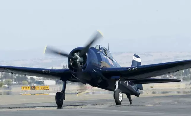 FILE - A World War II era F6F Hellcat taxis after landing at Mather Airport in Rancho Cordova, Calif. Friday Oct. 4, 2019. (AP Photo/Rich Pedroncelli, File)