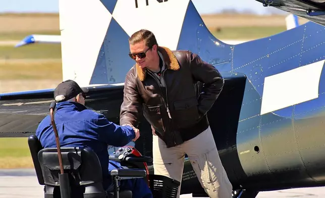 Donald McPherson, left, greets the pilot of a restored Hellcat, Steve Hinton Jr., at the Beatrice Municipal Airport in March 2021. (Dave Lyons/Beatrice Daily Sun via AP)