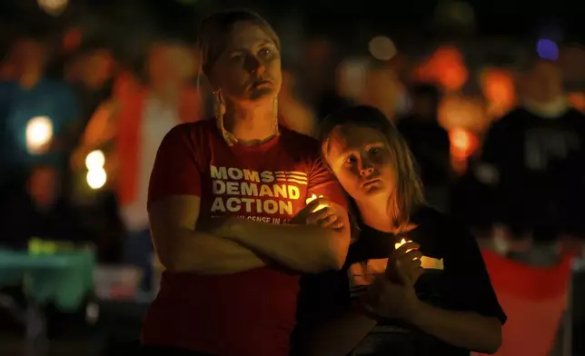 People gather at a vigil at Lynnhurst Park after a shooting at the Annunciation Catholic School Wednesday, Aug. 27, 2025, in Minneapolis. (AP Photo/Bruce Kluckhohn)