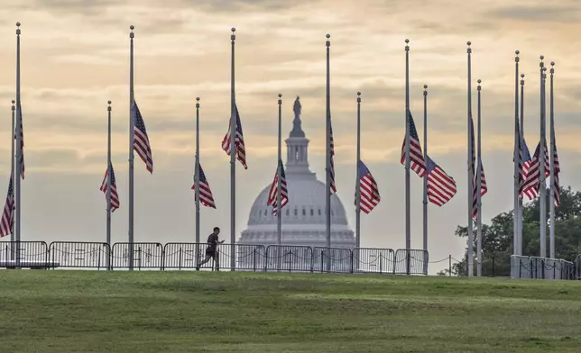 The flags circling the Washington Monument fly at half-staff in Washington, Thursday, Aug. 28, 2025, following the shooting at a Catholic church in Minneapolis. (AP Photo/J. Scott Applewhite)