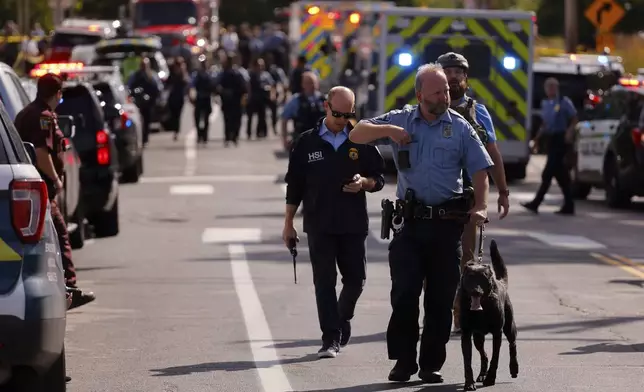 Law enforcement officers gather outside the Annunciation Church's school in response to a reported mass shooting, Wednesday, Aug. 27, 2025, in Minneapolis. (AP Photo/Bruce Kluckhohn)
