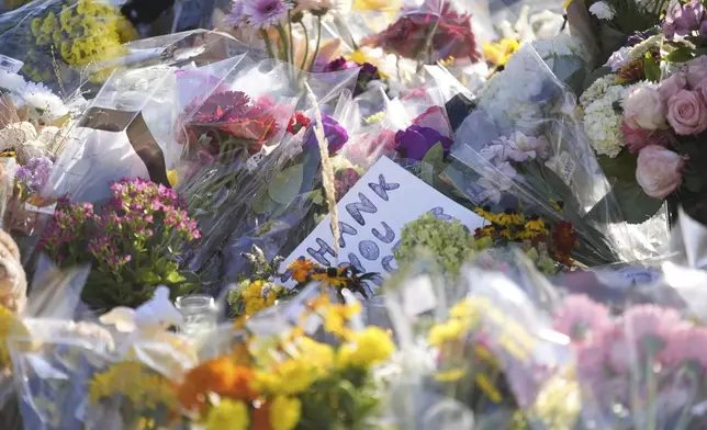 Flowers and notes are placed at a memorial at Annunciation Catholic Church after Wednesday's school shooting, Thursday, Aug. 28, 2025, in Minneapolis. (AP Photo/Abbie Parr)