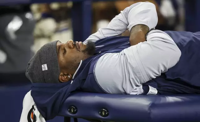 Dallas Cowboys defensive end Micah Parsons lies on the medical table during the second half of a preseason NFL football game against the Atlanta Falcons Friday, Aug. 22, 2025, in Arlington, Texas. (AP Photo/Gareth Patterson)