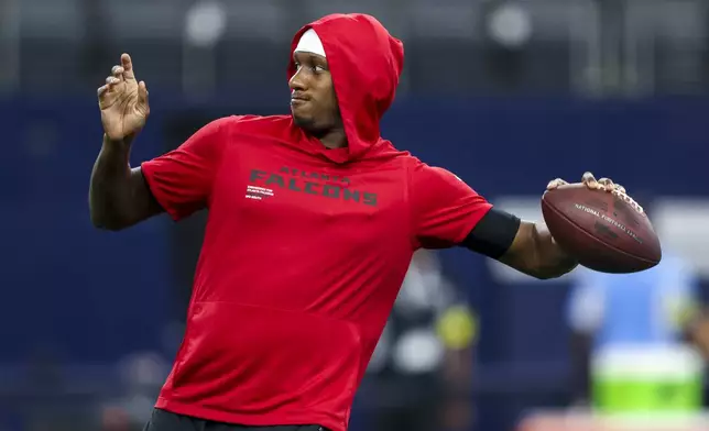 Atlanta Falcons quarterback Michael Penix Jr. works out prior to a preseason NFL football game against the Dallas Cowboys, Friday, Aug. 22, 2025, in Arlington, Texas. (AP Photo/Gareth Patterson)