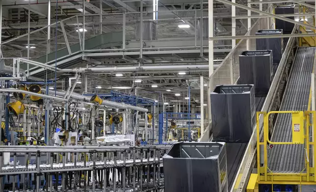 Components travel up a conveyor belt at GE Appliances global headquarters, Wednesday, Aug 13, 2025, in Louisville, Ky. (AP Photo/Jon Cherry)
