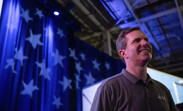 Kentucky Governor Andy Beshear stands near the event stage at GE Appliances global headquarters, Wednesday, Aug 13, 2025, in Louisville, Ky. (AP Photo/Jon Cherry)