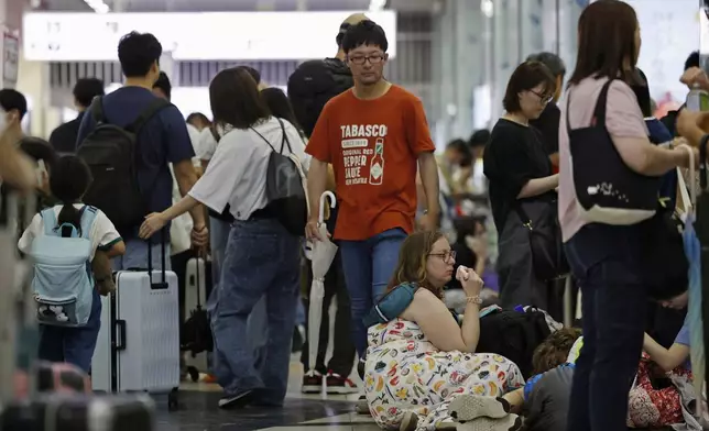 People crowd at Hakata station as bullet train services are suspended due to heavy rain, in Hakata, Fukuoka prefecture, southern Japan Monday, Aug. 11, 2025. (Takumi Sato/Kyodo News via AP)