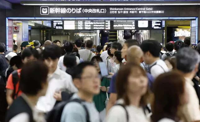 People crowd at Hakata station as bullet train services are suspended due to heavy rain, in Hakata, Fukuoka prefecture, southern Japan Monday, Aug. 11, 2025. (Takumi Sato/Kyodo News via AP)