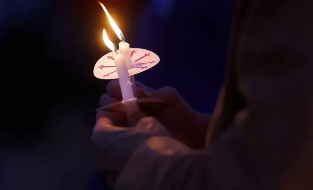 People gather at a vigil at Lynnhurst Park after a shooting at the Annunciation Catholic School Wednesday, Aug. 27, 2025, in Minneapolis. (AP Photo/Bruce Kluckhohn)