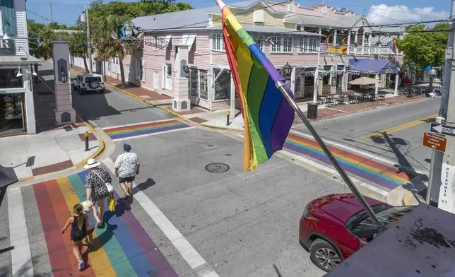 A family crosses one of four rainbow crosswalks on Duval Street in Key West, Fla., Tuesday, Aug. 26, 2025. (Rob O'Neal/The Key West Citizen via AP)