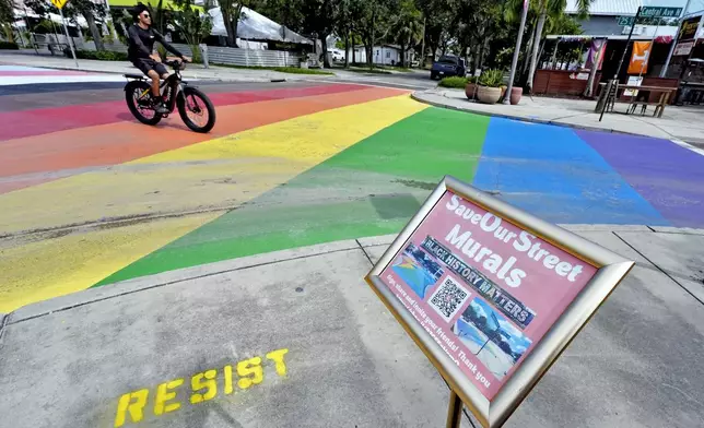 A cyclist crosses a rainbow-painted intersection Wednesday, Aug. 27, 2025, in St. Petersburg, Fla. (AP Photo/Chris O'Meara)