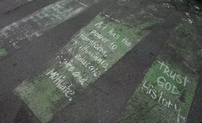 A worn street mural message outside the Dr. Carter G. Woodson African American Museum Wednesday, Aug. 27, 2025, in St. Petersburg, Fla. (AP Photo/Chris O'Meara)