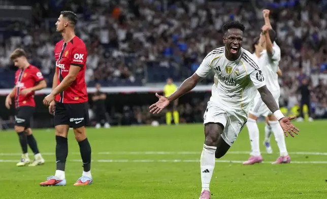 Real Madrid's Vinicius Junior, right, celebrates scoring his side's second goal during the Spanish La Liga soccer match between Real Madrid and Mallorca in Madrid, Saturday, Aug. 30, 2025. (AP Photo/Manu Fernandez)