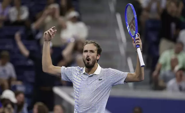 Daniil Medvedev, of Russia, gestures after a photographer ran onto the court during a match against Benjamin Bonzi, of France, in the first-round of the U.S. Open tennis championships, Sunday, Aug. 24, 2025, in New York. (AP Photo/Adam Hunger)