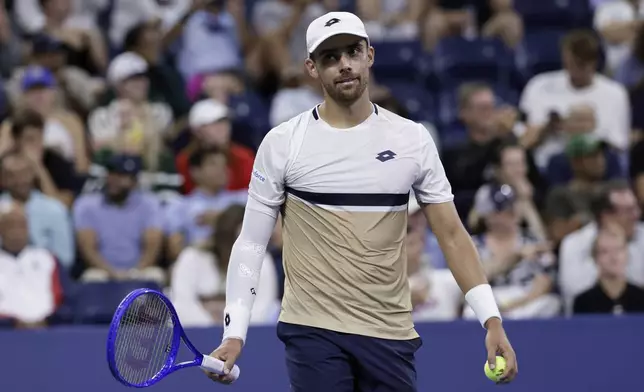 Benjamin Bonzi, of France, reacts during a match against Daniil Medvedev, of Russia, in the first-round of the U.S. Open tennis championships, Sunday, Aug. 24, 2025, in New York. (AP Photo/Adam Hunger)