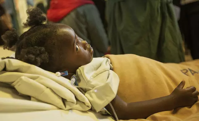 Kimberly Raisi lies on the bed as she recovers as she recovers from an open-heart surgery at Parirenyatwa Hospital, Harare, Zimbabwe, Thursday, July 17, 2025. (AP Photo/Aaron Ufumeli)