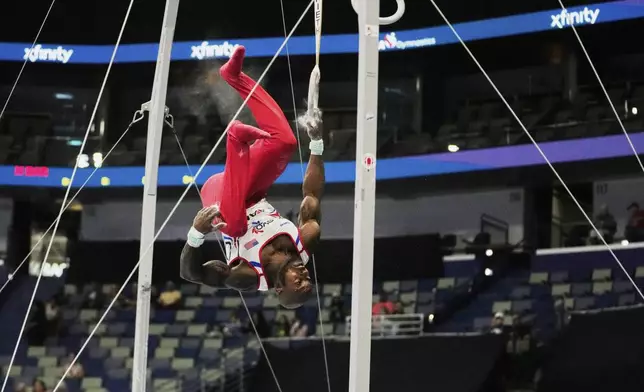 Donnell Whittenburg of EVO Gymnastics falls from the rings during the senior men's finals of the U.S. Gymnastics Championships in New Orleans, Saturday, Aug. 9, 2025. (AP Photo/Gerald Herbert)