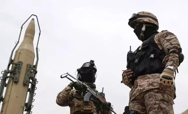 FILE—Iran's Revolutionary Guard members stand in front of Shahab-3 missile which is displayed during the annual pro-Palestinians Al-Quds, or Jerusalem, Day rally in Tehran, Iran, April 29, 2022. (AP Photo/Vahid Salemi, File)