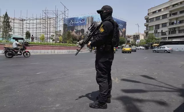 FILE—A member of Iran's Revolutionary Guard stands guard at Enqelab-e-Eslami (Islamic Revolution) square in downtown Tehran, Iran, June 24, 2025. (AP Photo/Vahid Salemi, File)