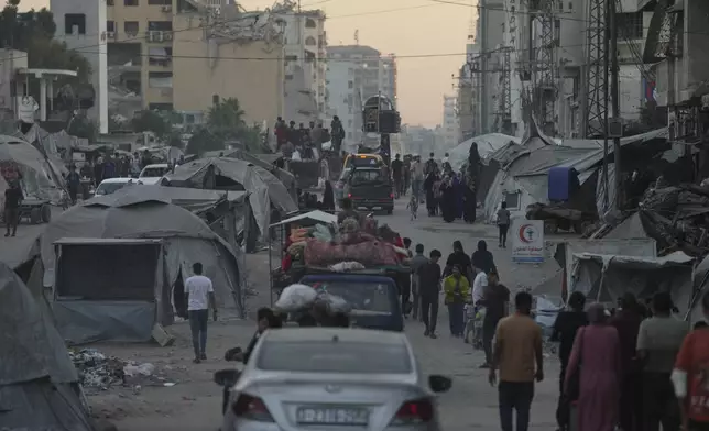 Displaced Palestinians fleeing northern Gaza Strip move with their belongings on a street in Gaza City, Friday, Aug. 29, 2025. (AP Photo/Jehad Alshrafi)