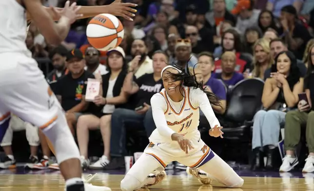 Phoenix Mercury forward DeWanna Bonner (14) passes the ball against the Chicago Sky during the second half of a WNBA basketball game Thursday, Aug. 28, 2025, in Phoenix. (AP Photo/Ross D. Franklin)