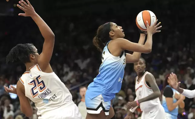 Chicago Sky forward Angel Reese, right, drives past Phoenix Mercury forward Alyssa Thomas (25) to score during the second half of a WNBA basketball game Thursday, Aug. 28, 2025, in Phoenix. (AP Photo/Ross D. Franklin)