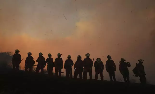A California Department of Corrections fire crew looks on as the Canyon Fire burns on Thursday, Aug. 7, 2025, in Hasley Canyon, Calif. (AP Photo/Marcio Jose Sanchez)