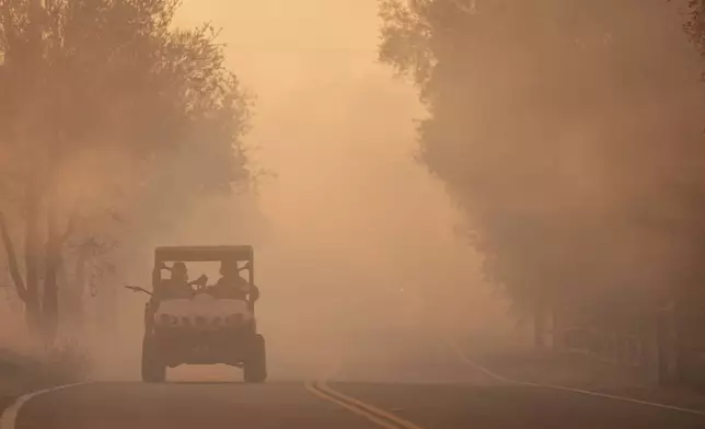 Residents evacuate as the Canyon Fire burns on Thursday, Aug. 7, 2025, in Hasley Canyon, Calif. (AP Photo/Marcio Jose Sanchez)