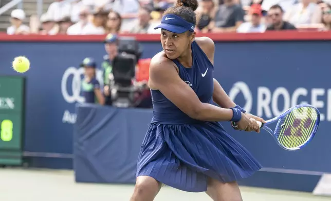 Naomi Osaka, of Japan, hits a return to Anastasija Sevastova, of Latvia, during round of 16 match action at the National Bank Open women's tennis tournament in Montreal, Sunday, Aug. 3, 2025. (Christinne Muschi/The Canadian Press via AP)
