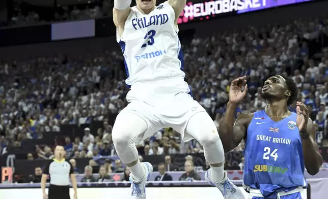 Lauri Markkanen of Finland and Carl Wheatle of Britain during Eurobasket, European Basketball Championship group B match between Finland and Britain in Tampere, Finland, Friday, Aug. 29, 2025. (Heikki Saukkomaa/Lehtikuva via AP)