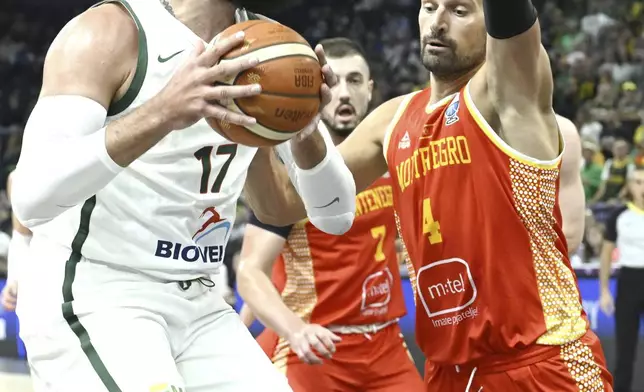 Jonas Valanciunas of Lithuania and Jonas Vucevic of Montenegro during the Eurobasket, European Basketball Championship group B match between Lithuania and Montenegro in Tampere, Finland, Friday, Aug. 29, 2025. (Heikki Saukkomaa/Lehtikuva via AP)