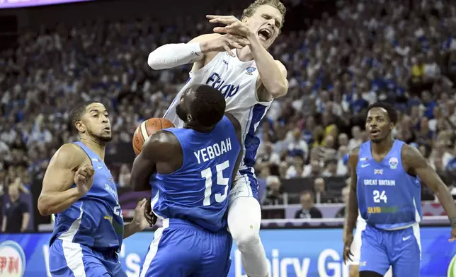 Lauri Markkanen of Finland and Akwasi Yeboah of Britain during Eurobasket, European Basketball Championship group B match between Finland and Britain in Tampere, Finland, Friday, Aug. 29, 2025. (Heikki Saukkomaa/Lehtikuva via AP)