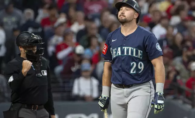 Seattle Mariners' Cal Raleigh reacts after a strike out by Cleveland Guardians starting pitcher Gavin Williams during the third inning of a baseball game, Saturday, Aug. 30, 2025, in Cleveland. (AP Photo/Phil Long)