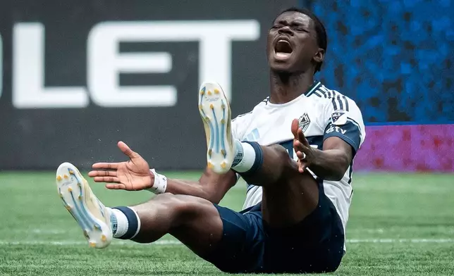 Vancouver Whitecaps' Emmanuel Sabbi protests after being tripped during the first half of an MLS soccer match against the Houston Dynamo in Vancouver, British Columbia, Sunday, Aug. 17, 2025. (Ethan Cairns/The Canadian Press via AP)